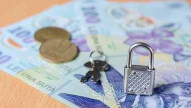 Lock and key on Romanian banknotes and coins representing concept of financial control in the European Union. The economic future of Romania after t
